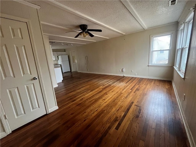 unfurnished living room with a textured ceiling, dark wood-type flooring, and ceiling fan