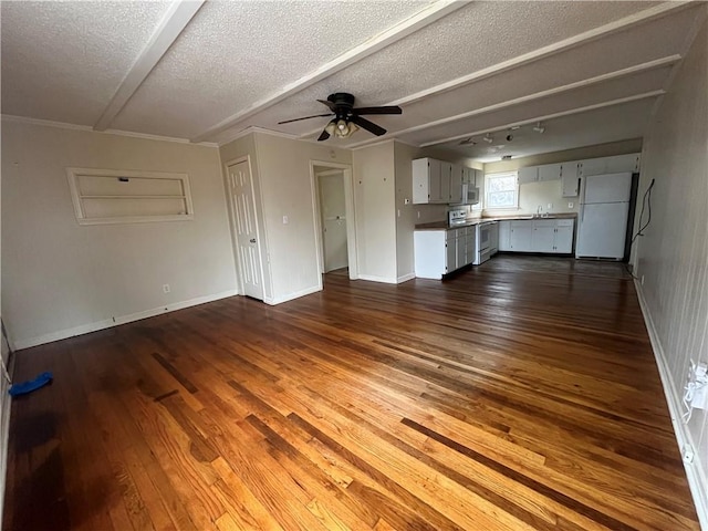 unfurnished living room with ceiling fan, dark hardwood / wood-style floors, and a textured ceiling