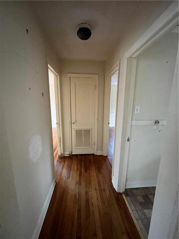 hallway with dark hardwood / wood-style flooring