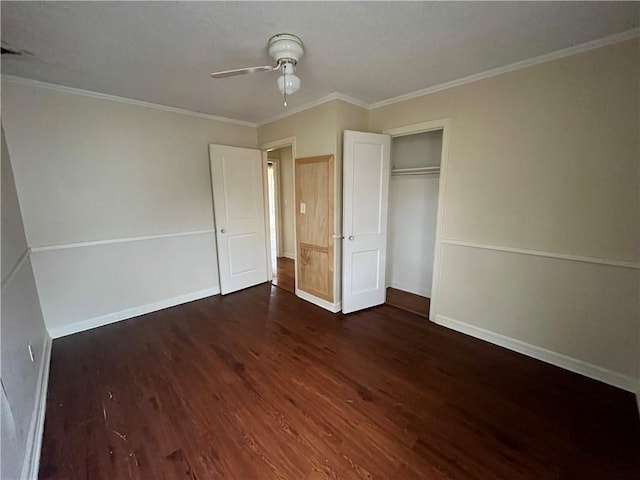 unfurnished bedroom featuring ornamental molding, dark hardwood / wood-style flooring, and a closet