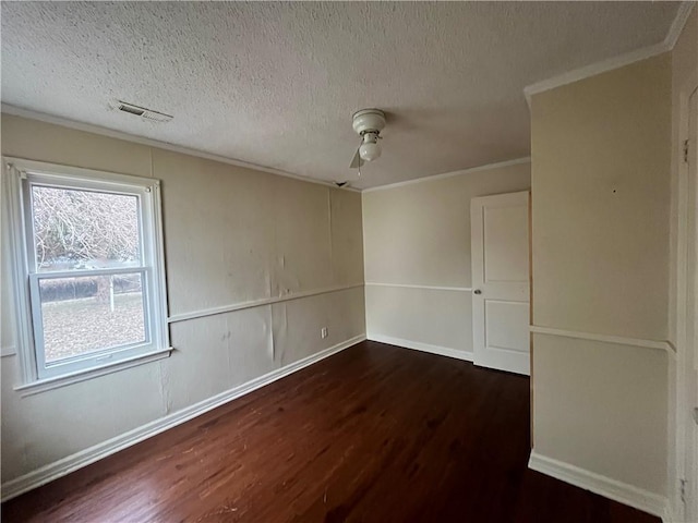 unfurnished room featuring crown molding, dark hardwood / wood-style floors, and a textured ceiling