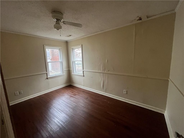 empty room featuring crown molding, dark wood-type flooring, a textured ceiling, and ceiling fan