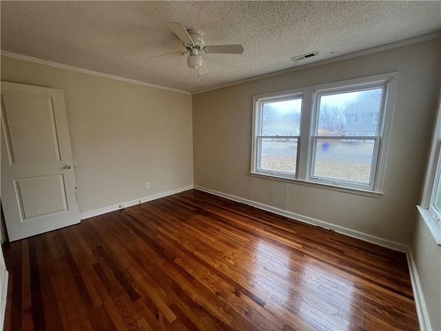 spare room with crown molding, ceiling fan, dark hardwood / wood-style flooring, and a textured ceiling