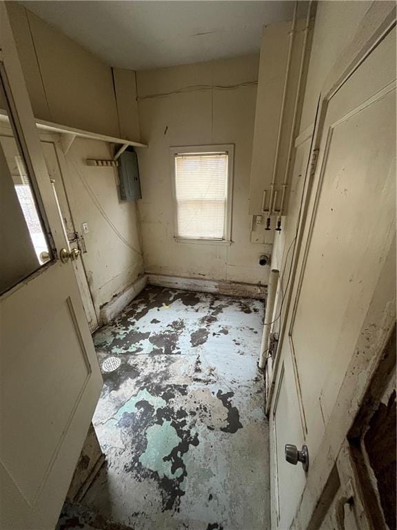 bathroom with concrete flooring and electric panel