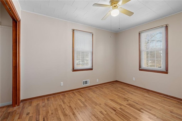 unfurnished room with crown molding, ceiling fan, and light hardwood / wood-style floors