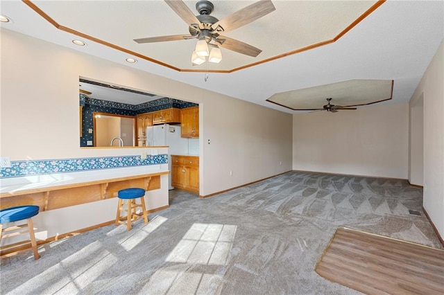 unfurnished living room with light colored carpet and ceiling fan