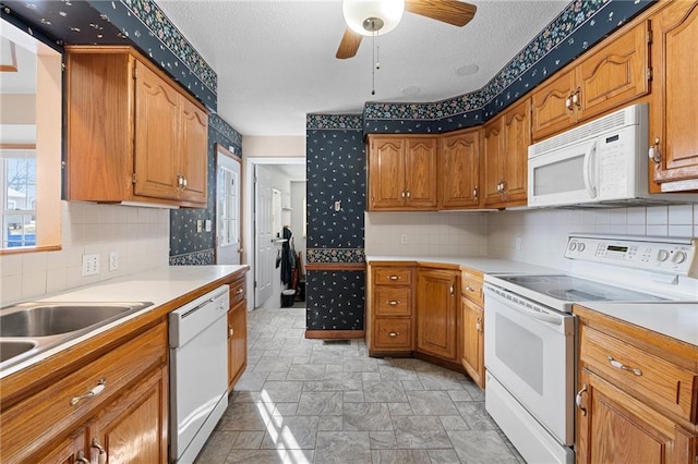 kitchen with ceiling fan, white appliances, tasteful backsplash, and a textured ceiling