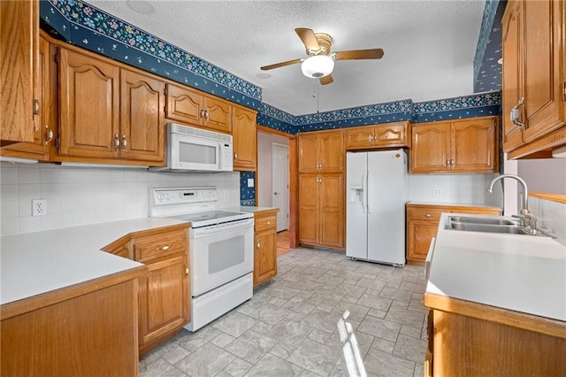 kitchen featuring sink, tasteful backsplash, white appliances, a textured ceiling, and ceiling fan