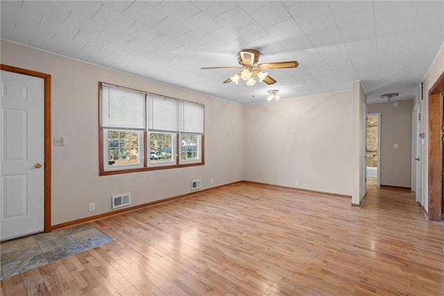 unfurnished living room with a ceiling fan, baseboards, visible vents, and light wood-type flooring