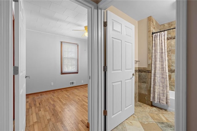 corridor featuring visible vents and light wood-style flooring