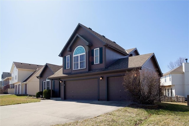 view of front facade with an attached garage, driveway, and a front lawn