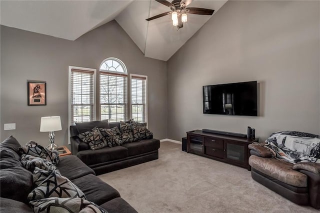 carpeted living area featuring a ceiling fan, baseboards, and high vaulted ceiling