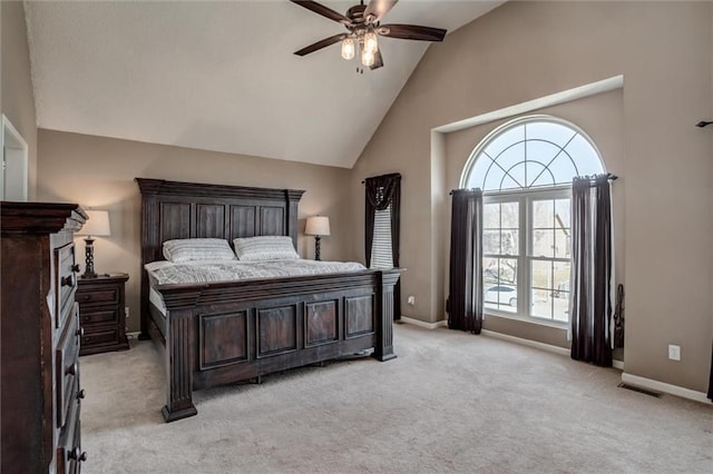 bedroom with visible vents, ceiling fan, baseboards, light carpet, and high vaulted ceiling