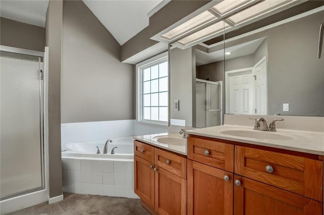 full bathroom with a garden tub, double vanity, a stall shower, and a sink