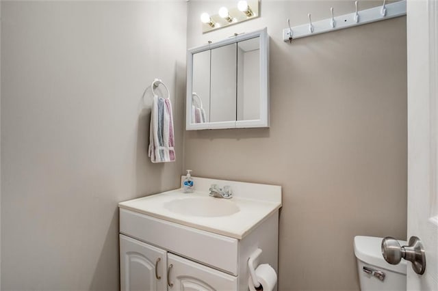 bathroom with toilet and vanity