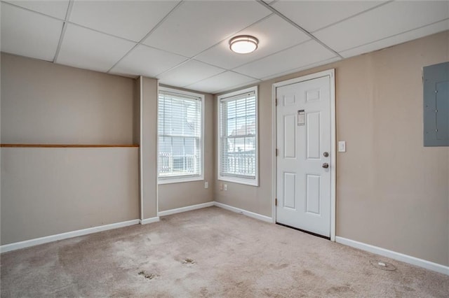 carpeted foyer featuring electric panel, a paneled ceiling, and baseboards