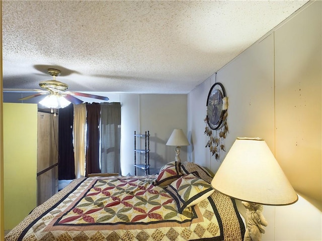 bedroom with ceiling fan and a textured ceiling