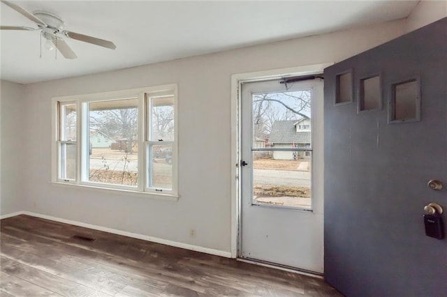 interior space with ceiling fan and dark hardwood / wood-style flooring