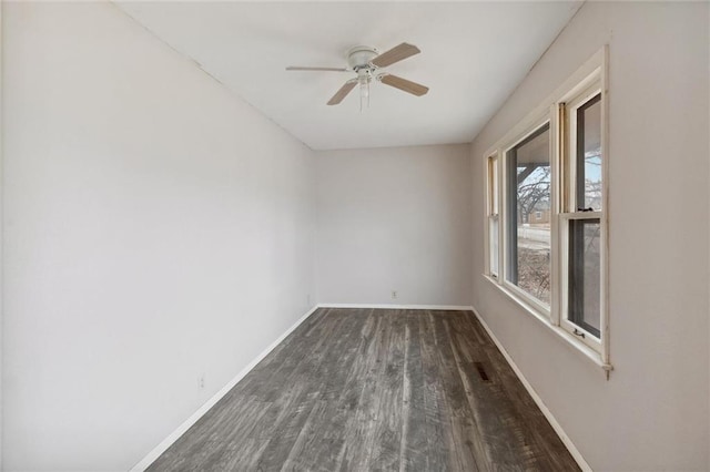 empty room with dark hardwood / wood-style floors and ceiling fan