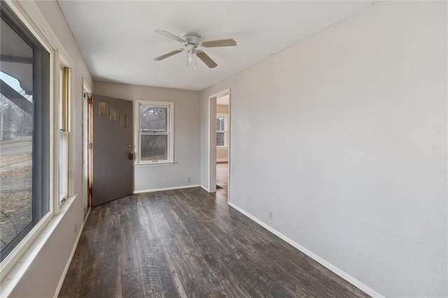 spare room featuring dark hardwood / wood-style floors and ceiling fan