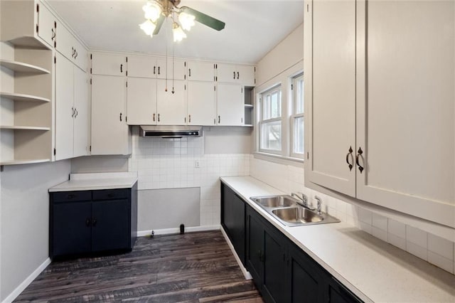 kitchen featuring dark wood-type flooring, ceiling fan, sink, and white cabinets