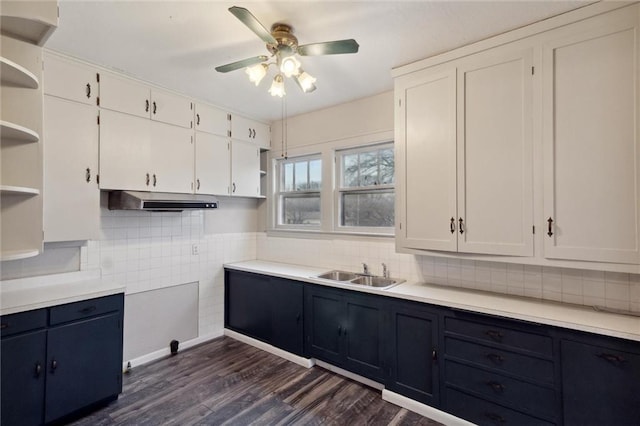 kitchen with sink, dark wood-type flooring, white cabinets, and decorative backsplash