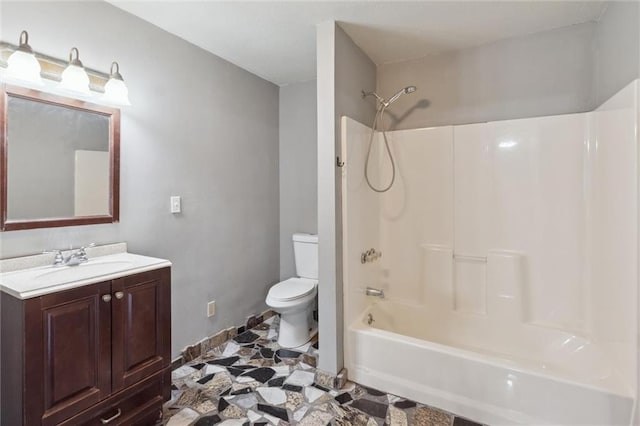 full bathroom featuring washtub / shower combination, vanity, and toilet