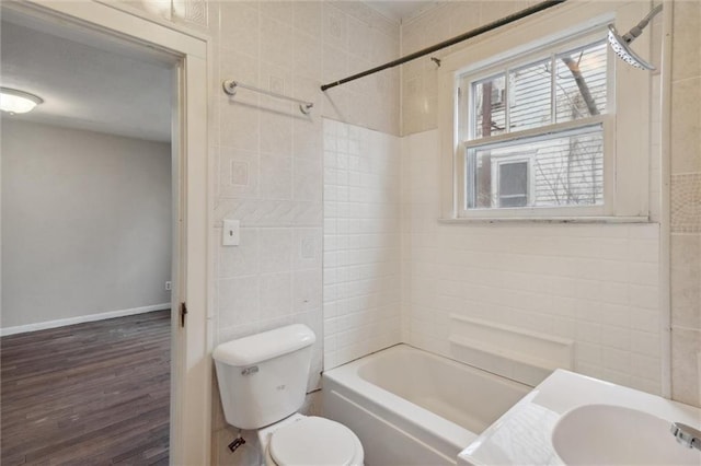 full bathroom featuring sink, tile walls, hardwood / wood-style floors, bathtub / shower combination, and toilet