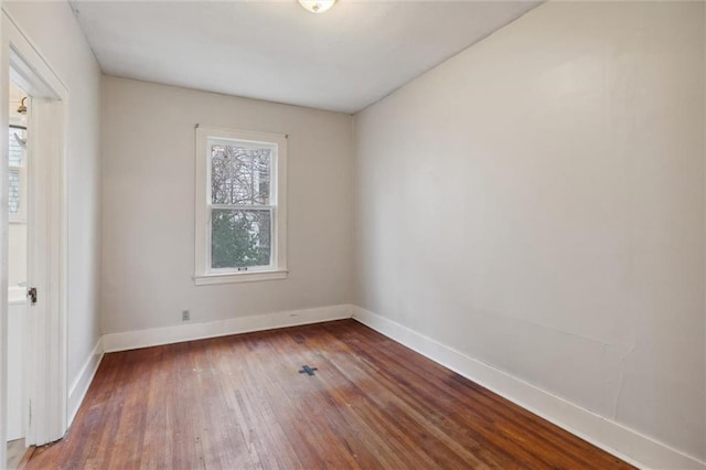 spare room with dark wood-type flooring