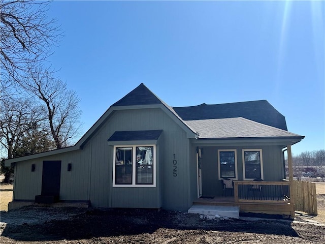 view of front of home with a porch and a shingled roof