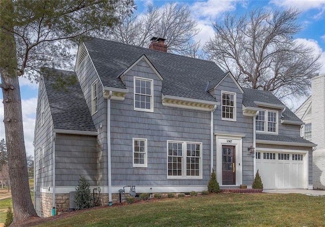 view of front of home with roof with shingles, a chimney, concrete driveway, an attached garage, and a front yard