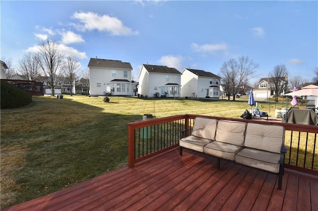 wooden deck featuring a yard, an outdoor living space, and a grill