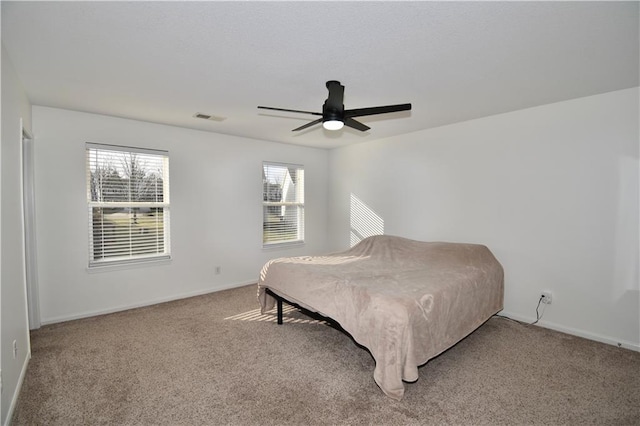 bedroom featuring ceiling fan and carpet