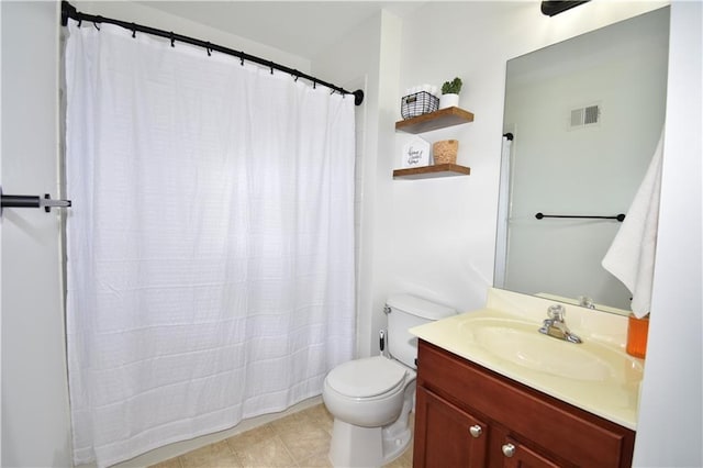 bathroom featuring vanity, tile patterned floors, and toilet