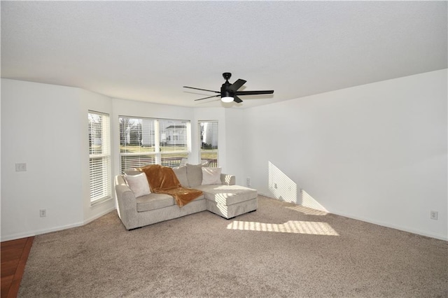 unfurnished living room featuring carpet flooring and ceiling fan