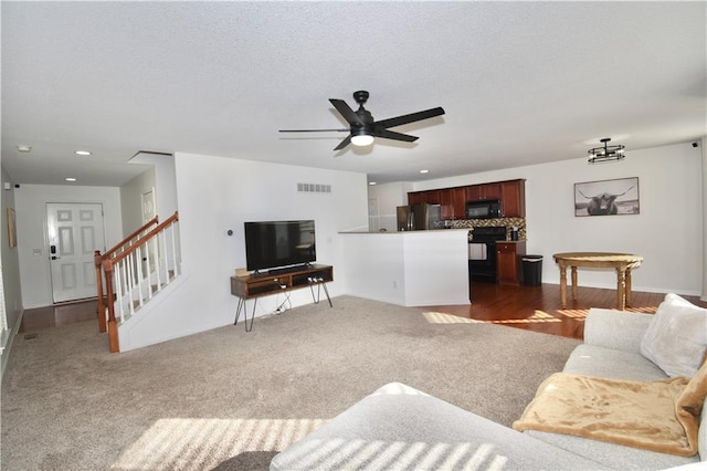 carpeted living room with ceiling fan