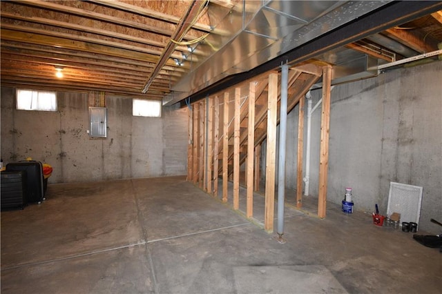 basement with a healthy amount of sunlight and electric panel