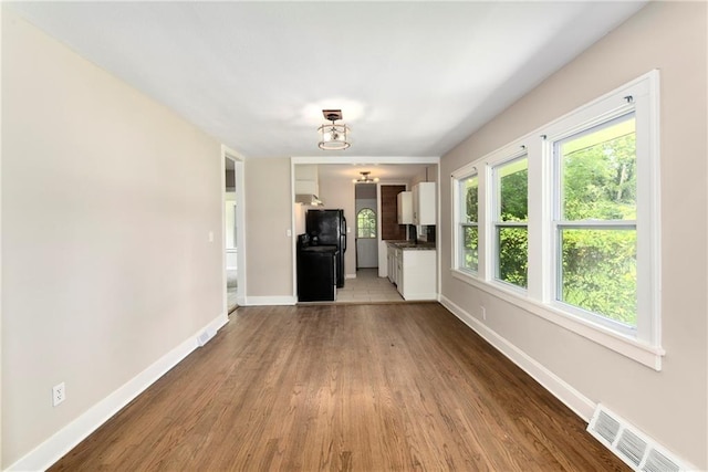 unfurnished living room with hardwood / wood-style flooring