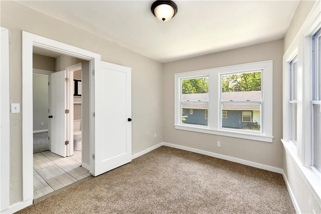 unfurnished room with light colored carpet