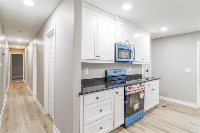 kitchen featuring white cabinetry, stainless steel appliances, and light hardwood / wood-style flooring