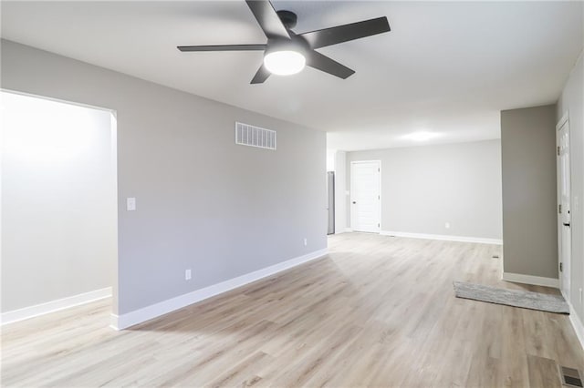 spare room featuring ceiling fan and light hardwood / wood-style flooring