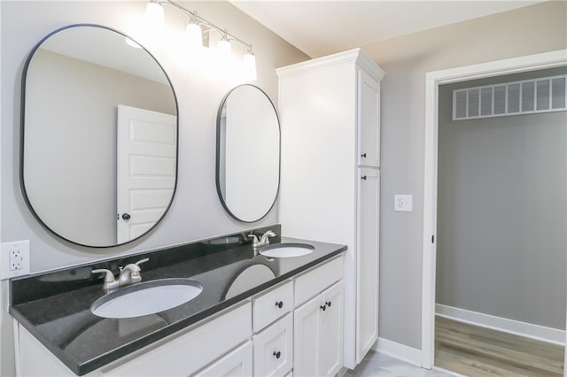 bathroom with vanity and hardwood / wood-style floors