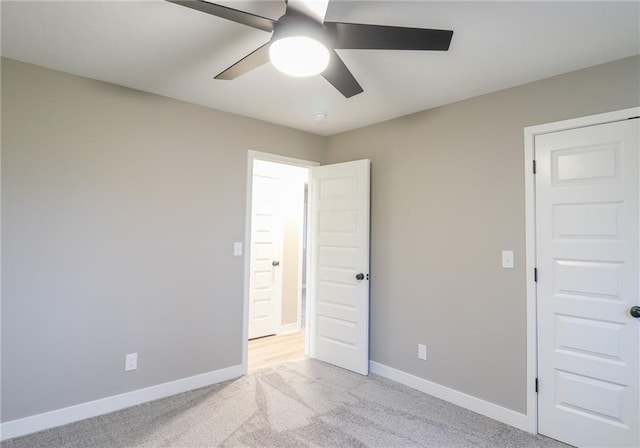 unfurnished bedroom featuring ceiling fan and light carpet