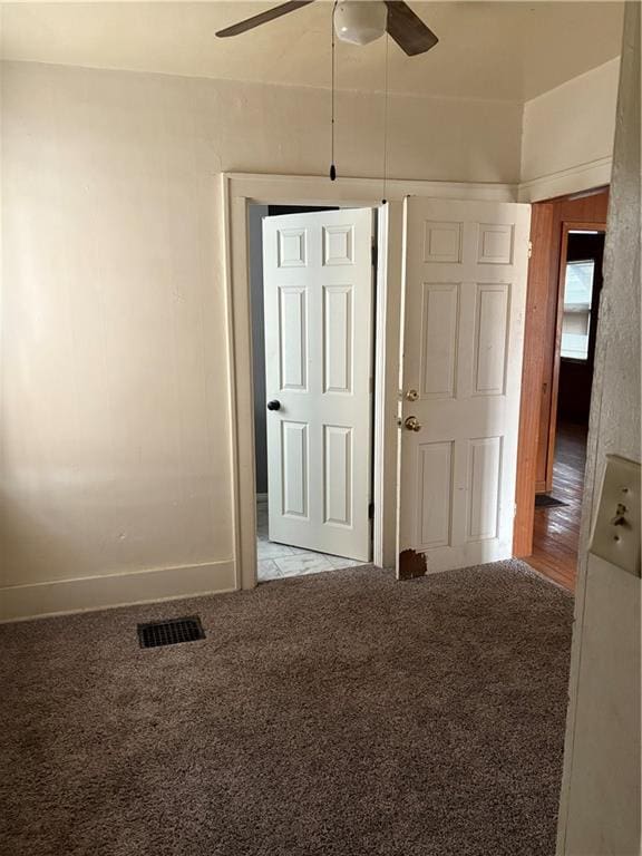 unfurnished room featuring light colored carpet and ceiling fan