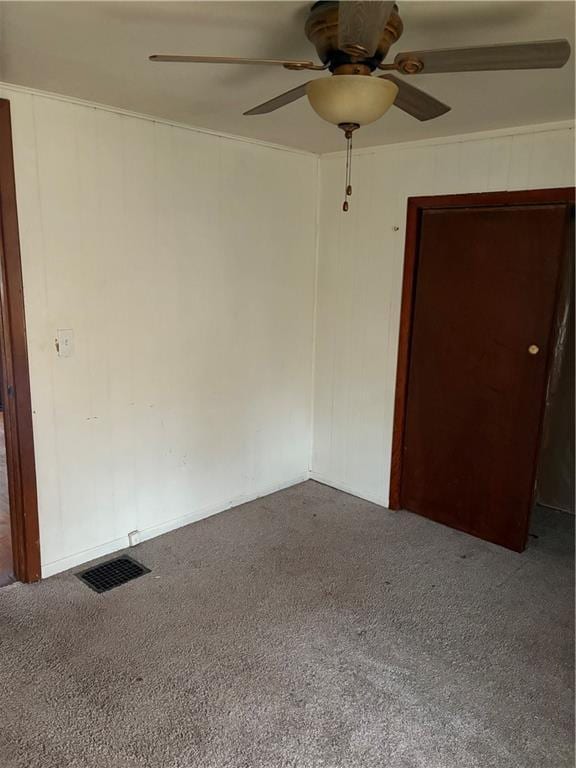 spare room featuring ceiling fan and carpet flooring