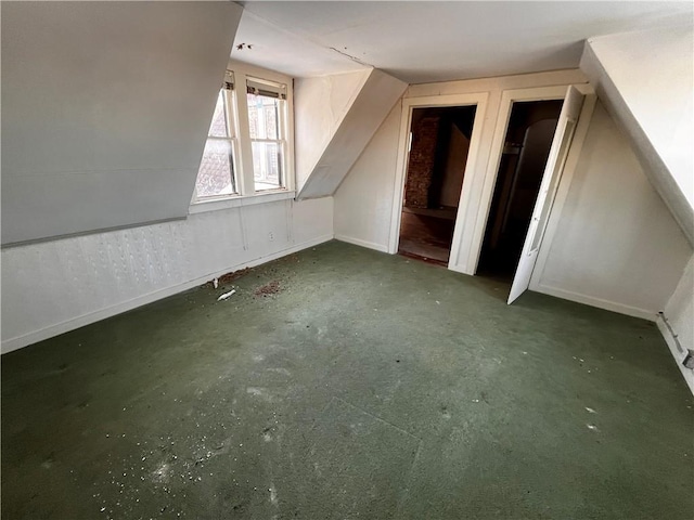 additional living space featuring lofted ceiling