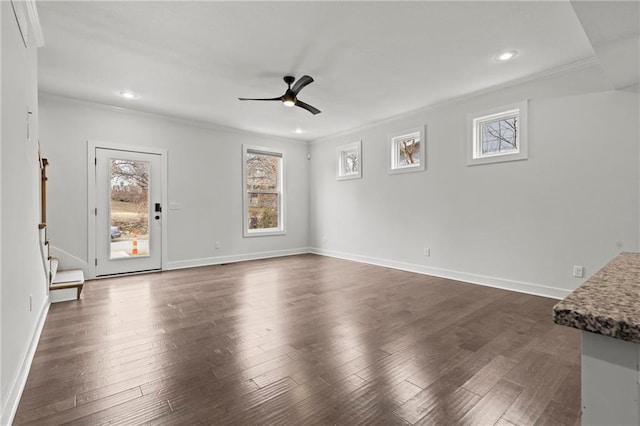 unfurnished living room with dark wood-type flooring, ceiling fan, and crown molding