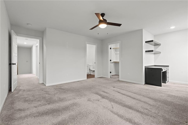 unfurnished living room with ceiling fan and carpet floors