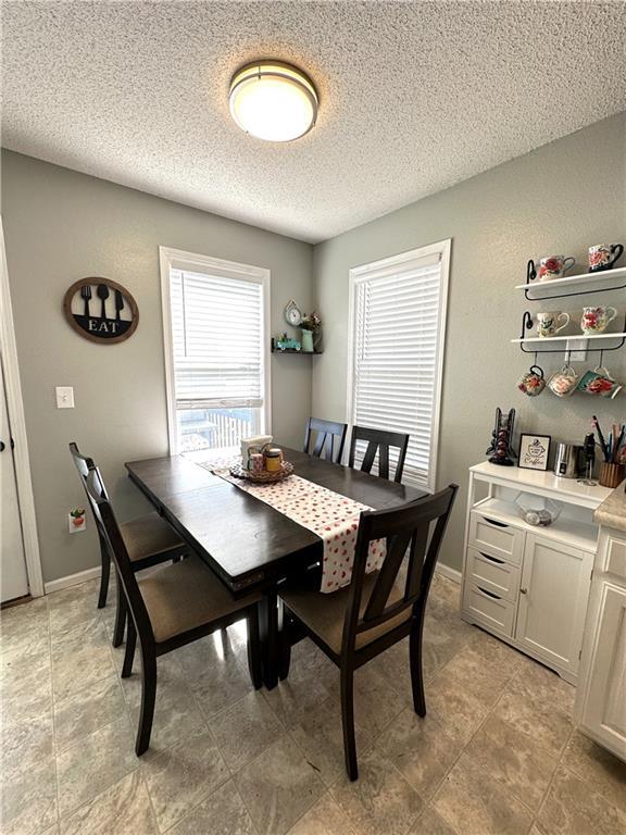 dining space with a textured ceiling