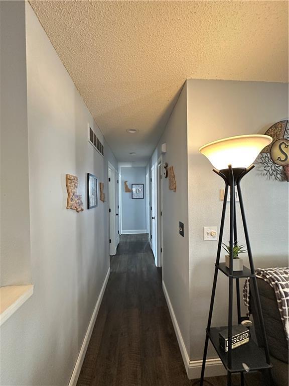 hallway featuring a textured ceiling